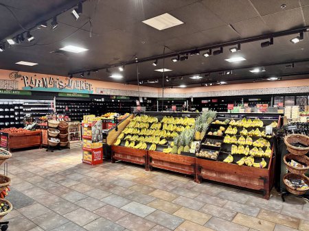 Photo for Twinsburg, OH, USA - August 25, 2023: Non-perishable produce is available in the Giant Eagle supermarket after a severe storm knocked out power, but the perishables that normally line the walls are gone. - Royalty Free Image