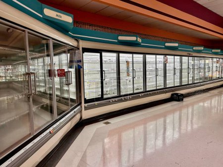 Photo for Twinsburg, OH, USA - August 25, 2023: Empty dairy cases line walls in the Giant Eagle supermarket after a severe storm during the previous night knocked out power. - Royalty Free Image