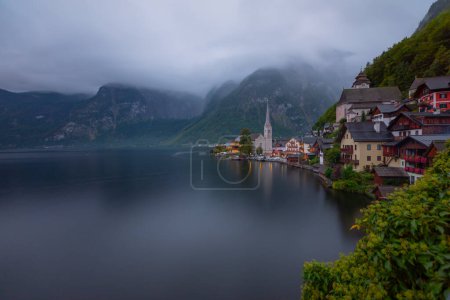 Scenic panoramic view of famous Hallstatt lakeside town reflecting in Hallstattersee lake in the Austrian Alps in scenic morning light on a beautiful sunny day in summer, Salzkammergut region, Austria
