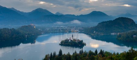 Aerial landscape photography. Colorful morning scene of Pilgrimage Church of the Assumption of Maria. Aerial autumn view of Bled lake, Julian Alps, Slovenia, Europe. Traveling concept background.