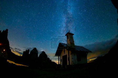Photo for Green tent lighted from the inside against the backdrop of incredible starry sky and Three Peaks of Lavaredo mountains. National Park Tre Cime di Lavaredo, Dolomites, Italy. Landscape photography - Royalty Free Image