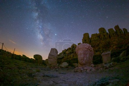 Photo for Ancient statues on the Nemrut mountain on the beautiful. Milky way galaxy. Unesco heritage. Nemrut, Turkey. Night landscape. - Royalty Free Image