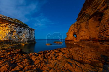 Photo for Long exposure on cliffs at night beach - Royalty Free Image