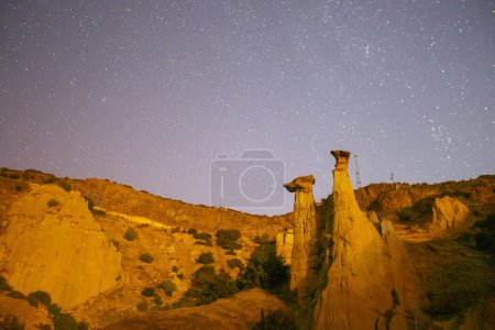 Photo for Night astronomical star and milky way photos in Kula fairy chimneys. Kula and its surroundings have a volcanic geological structure. - Royalty Free Image