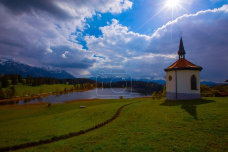 Farm chapel on a small lake ,Lake Hegratsried