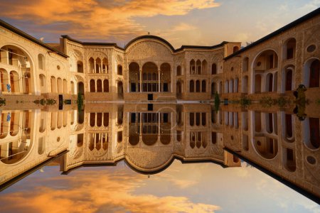 Photo for View of traditional Iranian courtyard with pool and fountains in the middle at Tabatabaei Historical House. Wonderful Persian architecture. Beautiful exterior. - Royalty Free Image