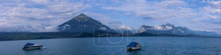 Photo for Aeiral panorama of Niesen mountain, also called as Swiss Pyramid with reflection on the Thun lake - Royalty Free Image