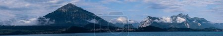 Aeiral panorama of Niesen mountain, also called as Swiss Pyramid with reflection on the Thun lake