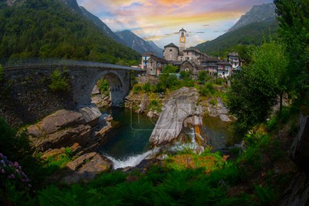 Photo for Traditional stone houses and a Church in the picturesque Lavertezzo village, Ticino, Switzerland. Lavertezzo is a popular travel destination in Verzasca valley in the swiss Alps mountains. - Royalty Free Image