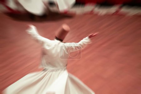 Dervishes perform on the stage for Mevlana