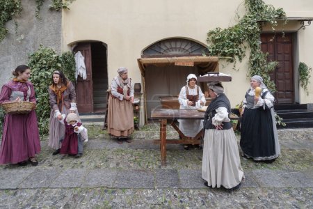 Taggia, Italy - February 26, 2023: Historical reenactment in the old town of Taggia, in Liguria region of Italy. The actors acting out episodes of daily life in settings that evoke moments of life lived fully the seventeenth century. The episodes dep