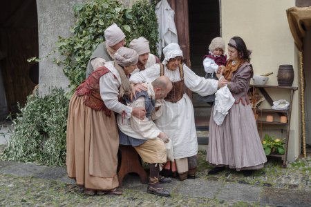 Photo for Taggia, Italy - February 26, 2023: Historical reenactment in the old town of Taggia, in Liguria region of Italy. The actors acting out episodes of daily life in settings that evoke moments of life lived fully the seventeenth century. The episodes dep - Royalty Free Image