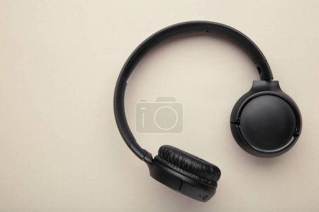 Photo for Black, modern wireless headphones on a grey background. Top view. - Royalty Free Image