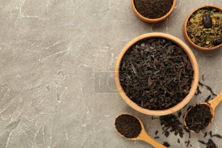 Assortment of dry tea on grey background. Space for text. Top view