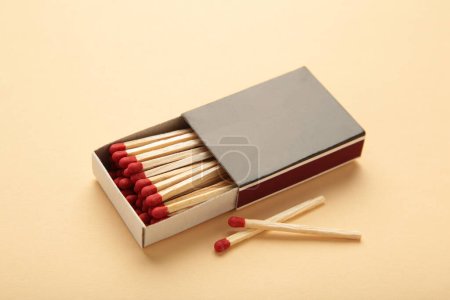 Box of matches on a beige background. Top view
