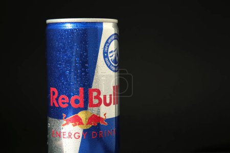 Photo for Mykolaiv, Ukraine - May 2, 2023: Red Bull Energy Drink in can with water drops on black background. Top view - Royalty Free Image
