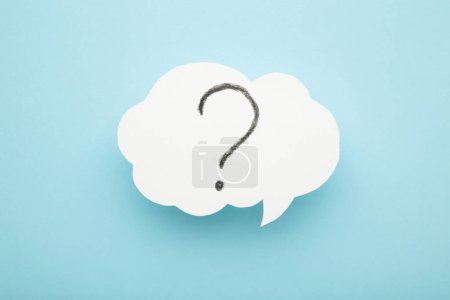 Photo for Question mark speech bubble on blue background. Top view - Royalty Free Image