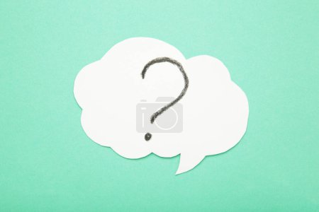 Photo for Question mark speech bubble on mint background. Top view - Royalty Free Image