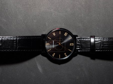 Foto de Top view of a water resistant black watch with leather strap on a black background - Imagen libre de derechos