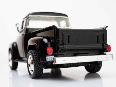 Téléchargez les photos : Rear view of a black truck miniature toys isolated on white - en image libre de droit