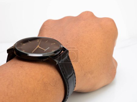 Foto de Water resistant black watch with leather strap wear by asian man - Imagen libre de derechos