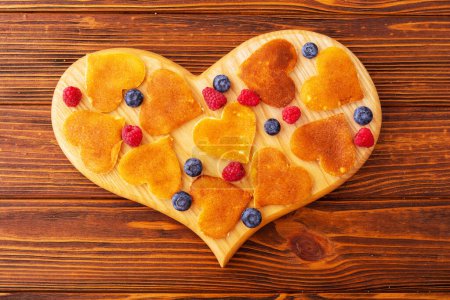 Photo for Small american mini pancakes in form heart ( love ) Top view - Royalty Free Image