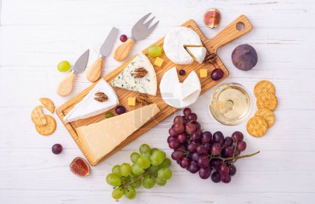 Photo for Differnt kind of cheese on the wooden board . Top view - Royalty Free Image
