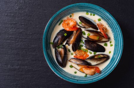 Cream soup with mussels . Sea food background photo