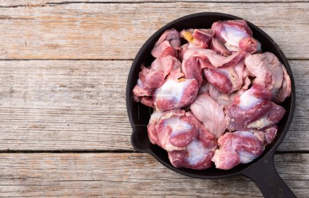 Raw chicken giblets gizzard ( stomach ) , meat background. Top view 