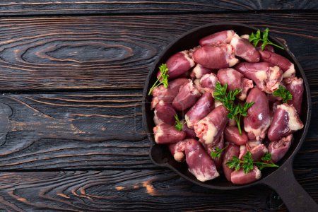 Raw chicken giblets hearts , meat background. Top view 