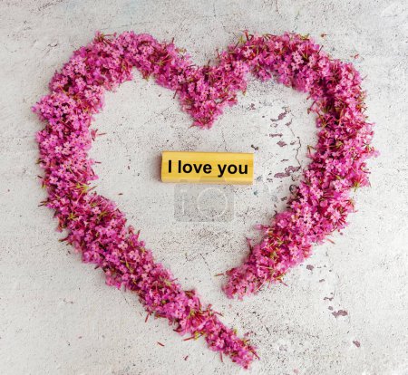 I love you text on wooden cube in Pink Flowers Heart Frame