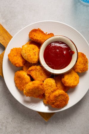 Photo for Overhead view of crisp nuggets on plate fast food and ketchup sauce - Royalty Free Image