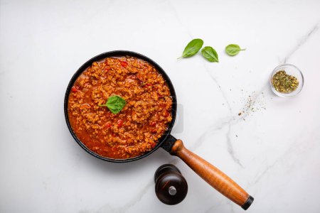 Photo for Meat sauce in pan bolognese on marble surface - Royalty Free Image