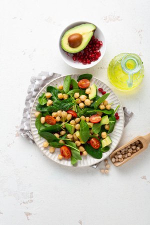 Überblick über gesunde Ernährung veganer Avocadosalat Kichererbsen auf heller Oberfläche