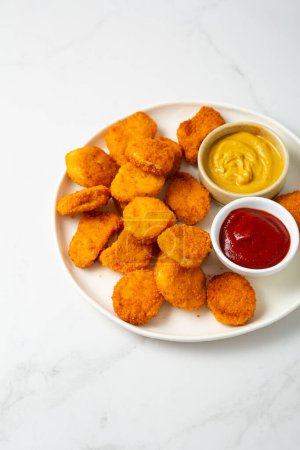 Photo for Close up of chicken nuggets on plate with sauce fastfood - Royalty Free Image