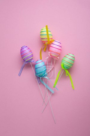 Photo for Happy Easter decorations eggs on pink surface holiday top view - Royalty Free Image