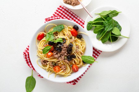 Photo for Tuna pasta spaghetti with cherry tomatoes food top view and spinach greens - Royalty Free Image