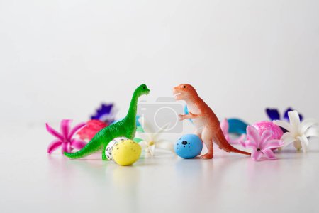 Foto de Toys of dinosaurs and Easter eggs, flowers  holiday concept - Imagen libre de derechos