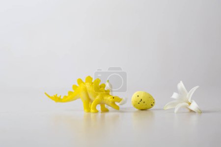 Photo for Yellow Easter egg and small animal toy - Royalty Free Image