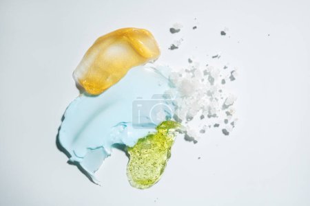 Photo for Creme blue swatch green gel golden cosmetics smudge top view - Royalty Free Image