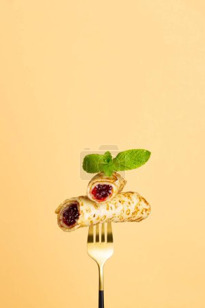 Photo for Close up of crepes pancake with jam on fork food background - Royalty Free Image