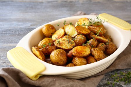 Photo for Potatoes roasted in the baking dish, food close-up - Royalty Free Image
