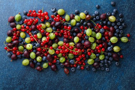 Photo for Summer organic berries on bluee background gardening, harvest, diet and healthy eating concept - Royalty Free Image