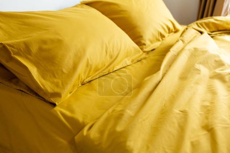 Photo for Fragment of yellow bed linen pillow and blanket - Royalty Free Image