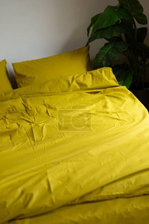 Photo for Fragment of yellow cotton bed linen pillow and blanket - Royalty Free Image