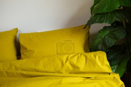Photo for Fragment of yellow cotton bedding pillow and blanket - Royalty Free Image