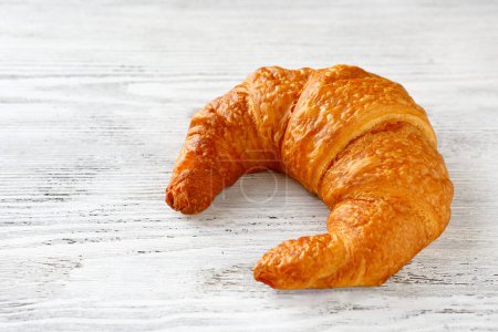 Photo for One French croissant close up of white surface - Royalty Free Image