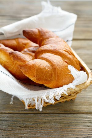 Photo for Two croissants in the bread basket food closeup - Royalty Free Image
