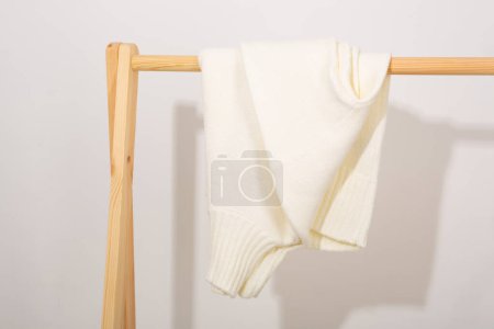 Photo for White sweater close up on a hanger women's clothing - Royalty Free Image