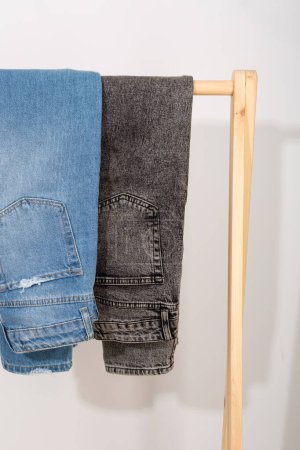 Photo for Two pairs of jeans hanging on a clothing rack - Royalty Free Image